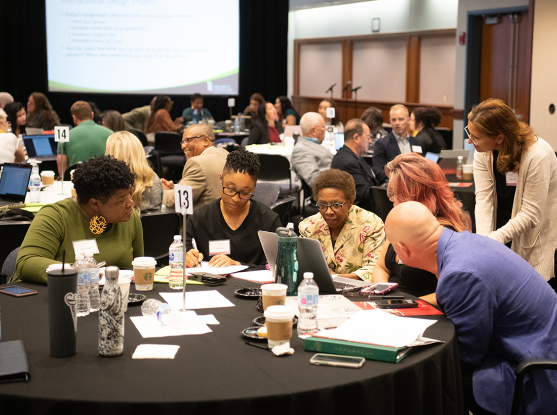 School of Pharmacy Dean Natalie D. Eddington, PhD, FCP, FAAPS, at the laptop, works with students in the MS in Medical Cannabis Science and Therapeutics program during the 2019 Symposium at the Universities at Shady Grove.