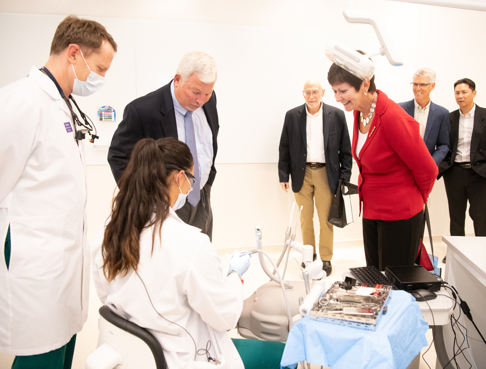 Third-year School of Dentistry students Ben Horn, left, and Sahar Nesvarderani demonstrate techniques for guests during the grand opening of the Biomedical Sciences and Engineering Education Facility at the Universities at Shady Grove.  