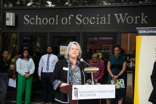 Dean Judy Postmus speaks in front of the School of Social Work building during the Aug. 24 news conference to announce a $5.5 million grant from the U.S. Department of Education.