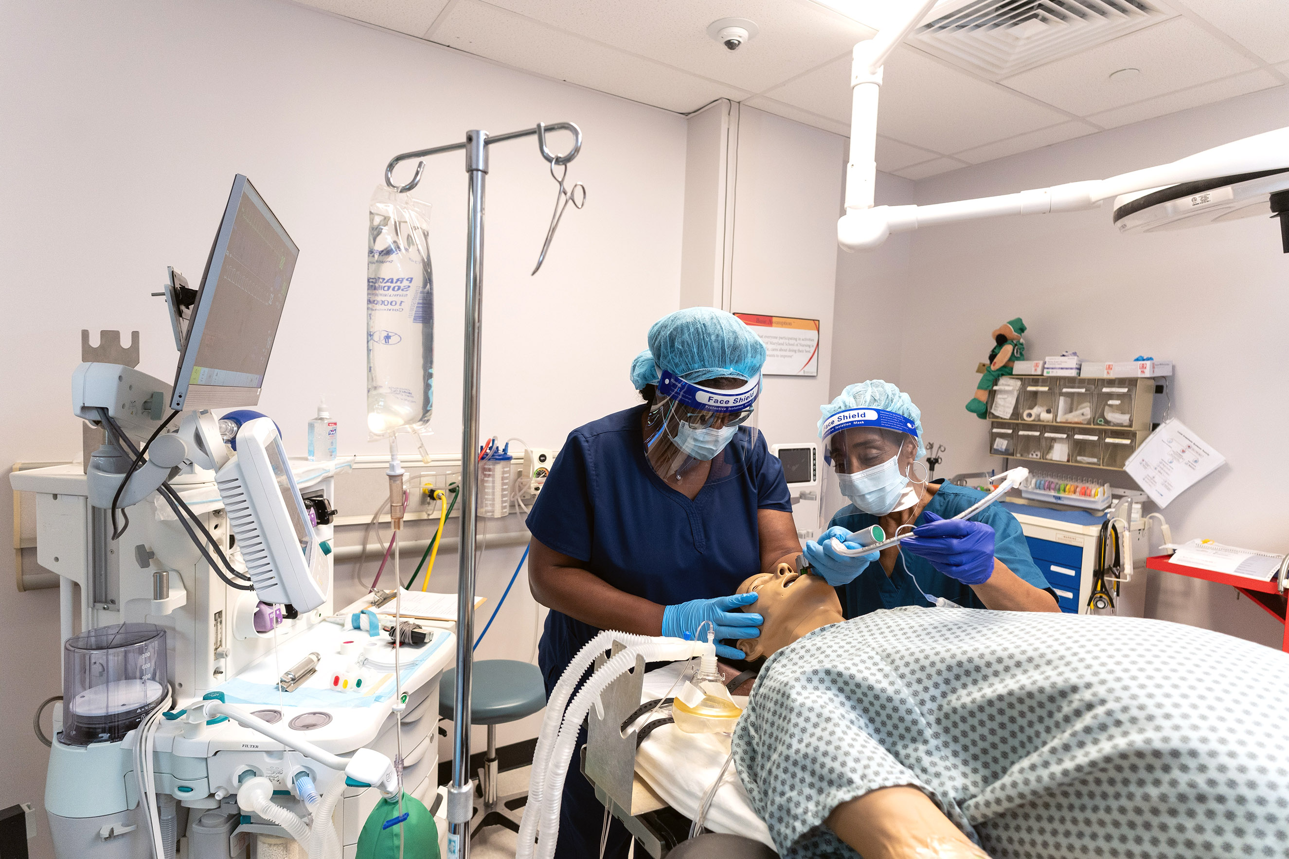 Nursing students practice caring for a simulated patient.