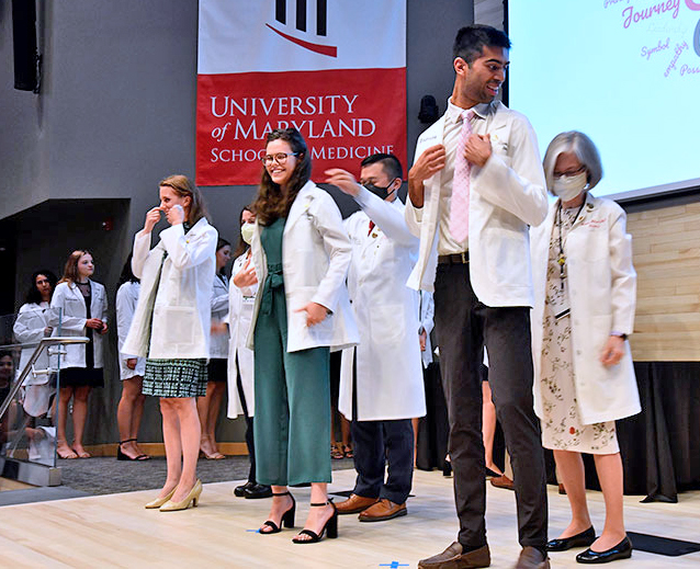 Members of the UMSOM Class of 2025 receive their first white coats. 