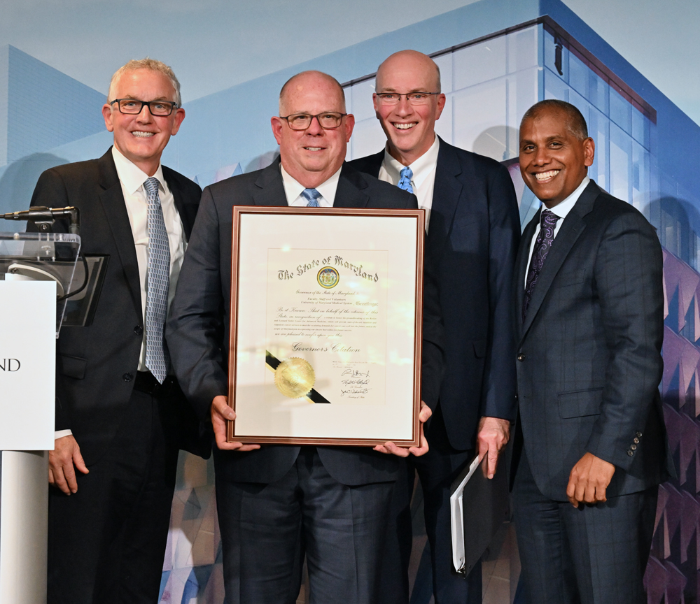 (l-r) Dr. Bert O'Malley, Gov. Larry Hogan, Dr. Kevin Cullen, and Dr. Mohan Suntha pose with a governor's declaration in honor of the Stoler Center for Advanced Medicine.
