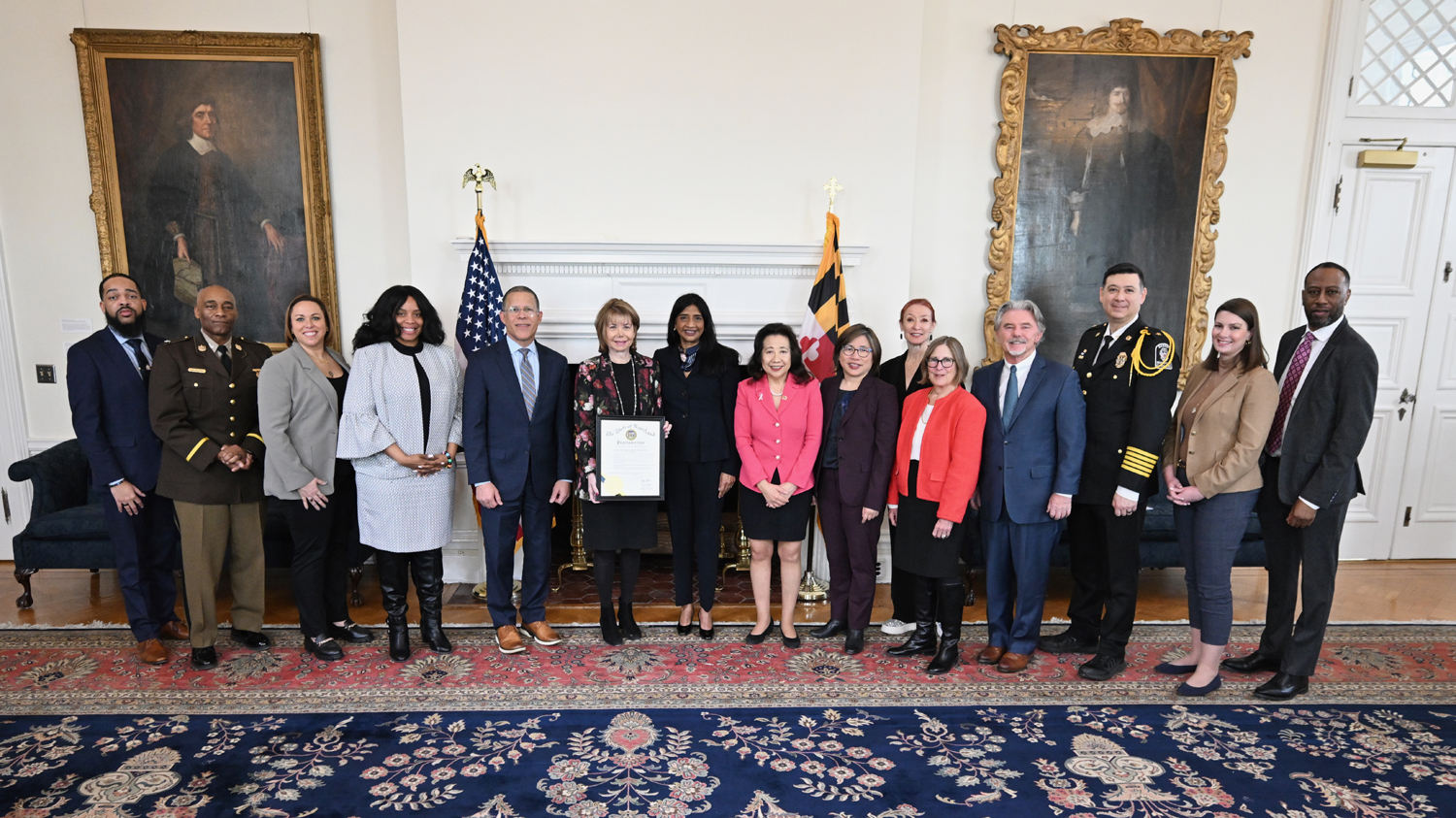 UM SAFE Center COO Susan Esserman holds proclamation, flanked on her left by Lt. Gov. Miller, Secretary of State Lee, and Secretary of Labor Wu, and on her right by Attorney General Anthony Brown and Survivor Stacy Jewell
