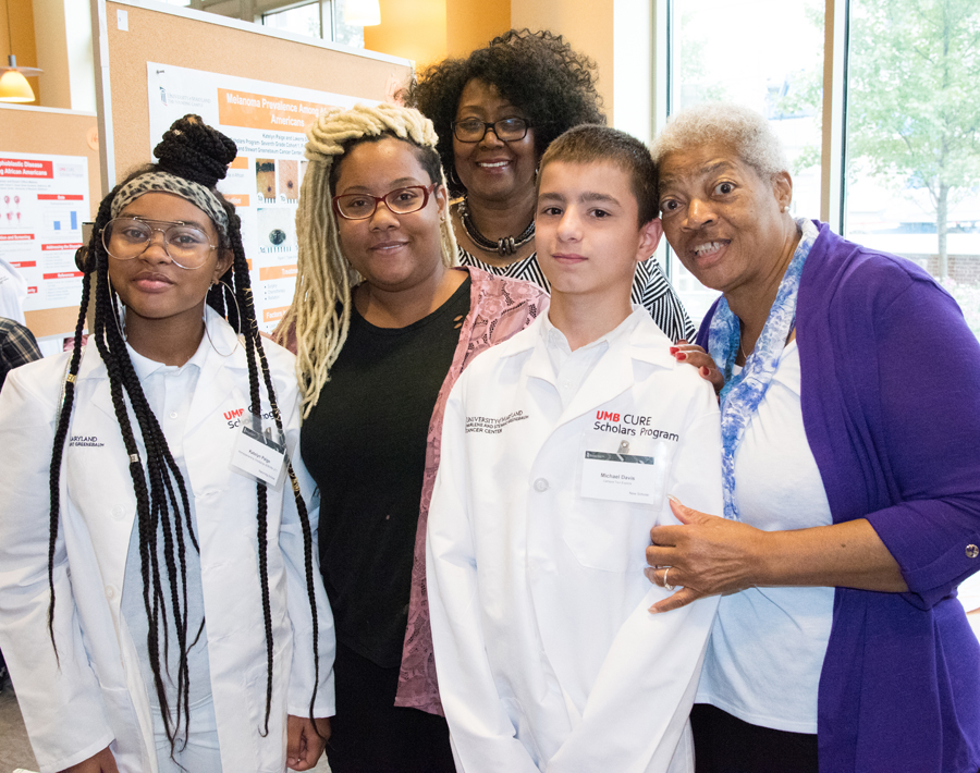 Third year UMB Scholar, Katelyn Paige, and her mother, Karin Soden, stand with Michael Davis, who was just inducted into the CURE Scholars Program, and his mother, Janis Davis, who is also Katelyn's great grandmother.  Also pictured is Terry F. Patton, principal of Franklin Square Elementary/Middle, which Katelyn and Michael both attend. 