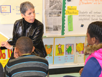 SSW Assistant Dean Bronwyn Mayden, MSW, executive director of Promise Heights, reads to children at the Historic Samuel Coleridge-Taylor Elementary School.