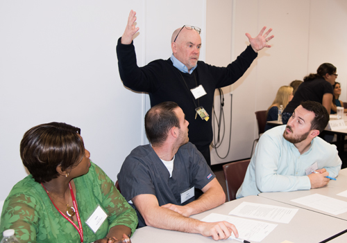 During an exercise highlighting interprofessional education, Dr. Vincent Conroy, an assistant professor with the Department of Physical Therapy and Rehabilitation Science at the University of Maryland School of Medicine, reminds students from multiple disciplines to take a 