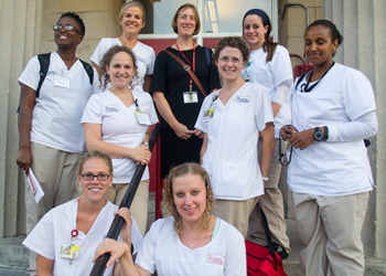 Kate Scott, MPH, RN, top center, instructs UMSON students who work with children on a weekly basis at The Historic Samuel Coleridge-Taylor Elementary School, where the nursing students gathered after participating in back-to-school night. 