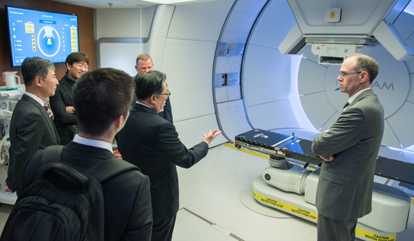 Pusan National University Yangsan Hospital President Hwan-Jung Roh asks Jim Hughes a question in one of the MPTC treatment rooms.