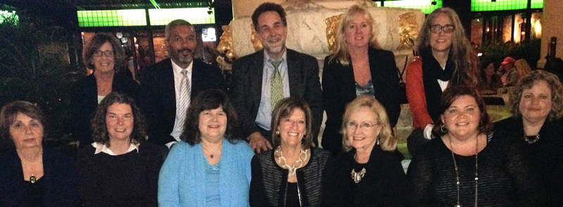 Gathered for the NTI launch are, from left, back row, Sarah Greenblatt; Devon Brooks; SSW Dean Richard P. Barth; Leslie Savary; and Meredith Waudby of SSW; front row, Edythe Swidler; Bethany Lee of SSW; Susan Livingston Smith; principal investigator for NTI and CASE CEO Debbie Riley; Anne Atkinson; Marlene Matarese, SSW's principal investigator for NTI; and Valerie Kunsman.