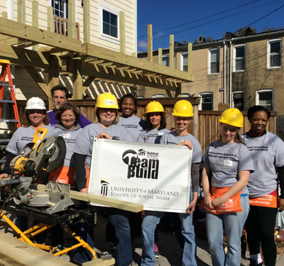 Volunteers from the University of Maryland School of Social Work helped construct decks on a row of townhomes in the Pigtown neighborhood of Baltimore with Habitat for Humanity of the Chesapeake. Dean Richard Barth is second from left.   