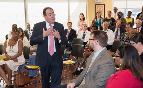 President Perman speaks to UMB staff and community residents about the new computers available at the Community Engagement Center.