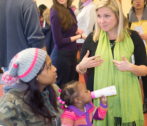 Ashley Valis, MSW, speaks with Jasmine Roane and daughter Hailey.