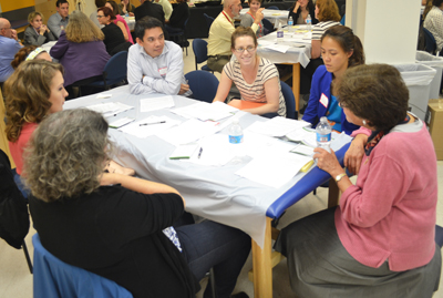 Students confer with Reba Cornman, MSW, about a geriatric case study at the GGEAR IPE conference.