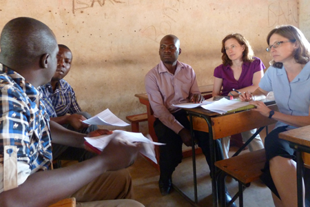 In Malawi, IGH researchers Lauren Cohee, MD, right, and Miriam Laufer, MD, second from right, meet with school leaders and research staff to plan a study to treat children for malaria in schools.