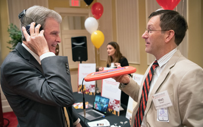 University of Maryland School of Dentistry Dean Mark Reynolds, DDS, PhD, MA, experiences what hearing sounds is like with a cochlear implant with Matt Goupell, PhD, associate professor in the Department of Hearing and Speech Sciences at College Park. 