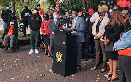 Dean Donald Tobin (third from left) listens as Baltimore Mayor Brandon Scott announces ARPA funding focused on crime reduction and victims' services.