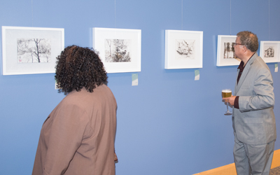 Guests view Maryland First Lady Yumi Hogan's artwork at the Weise Gallery