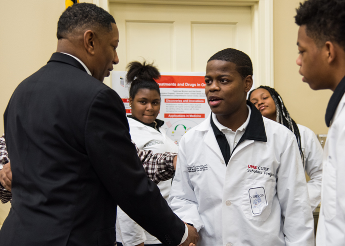 Shakeer Franklin (right), a cohort one scholar, shakes hands with Baltimore City Del. Keith Haynes (left) after presenting his research poster at the House Office Building.