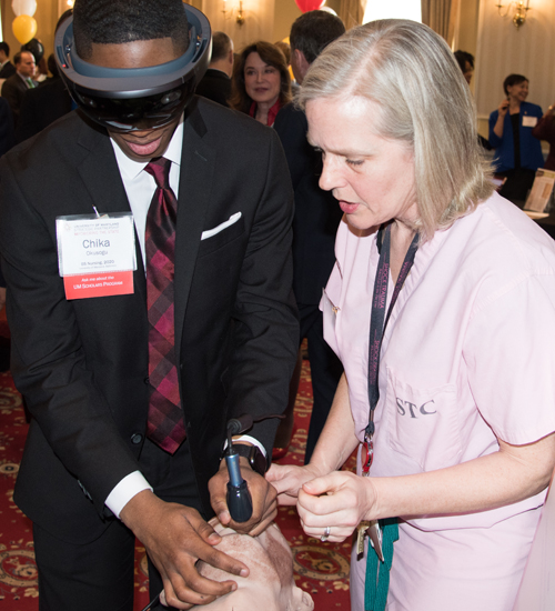 University of Maryland School of Nursing student Chika Okusogu, also a UM Scholar, participates in a demonstration conducted by Sarah B. Murthi, MD, associate professor at the University of Maryland School of Medicine and a trauma surgeon at the R Adams Cowley Shock Trauma Center. Murthi is part of a team studying the use of virtual reality in medicine. 