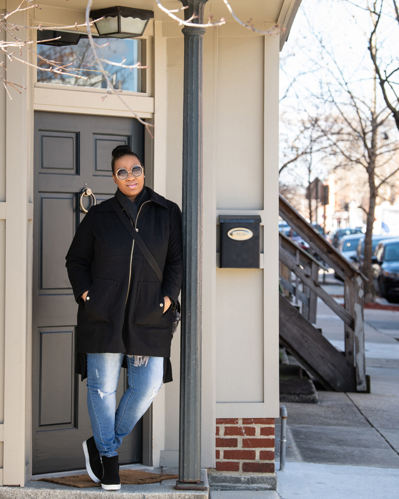 Tamara Hicks stands outside her new home in the Hollins Market neighborhood.