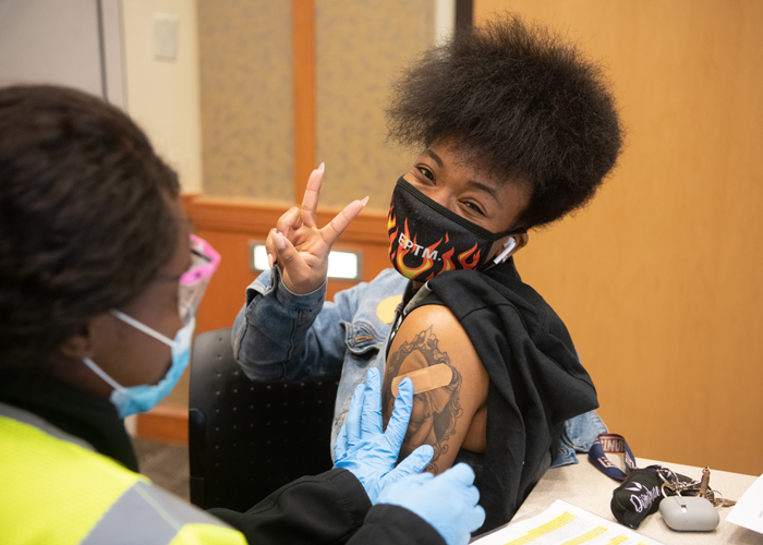 During the first week of the UMB-led vaccine clinic in the SMC Campus Center, Naya White received her first shot of the vaccine.