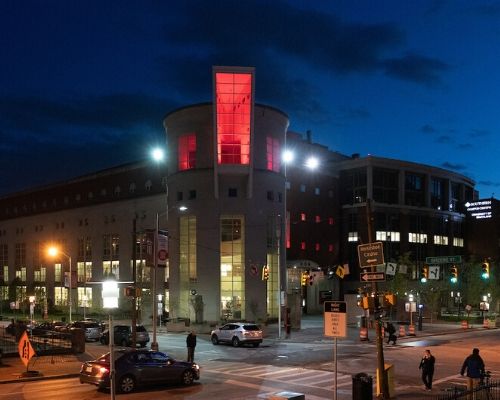 The Health Services and Human Sciences Library is one of several UMB buildings dressed in red lights to honor heroes working on the front lines during the COVID-19 pandemic. 