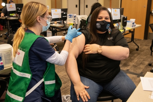 National Council of Urban Indian Health CEO Francys Crevier receives her first dose of a COVID-19 vaccine from Isabel Sangiorgi, a University of Maryland School of Nursing student who is volunteering as a vaccinator at the University of Maryland, Baltimore Vaccination Clinic. MATTHEW PAUL D'AGOSTINO/UMB 