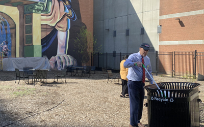 UMB President Bruce Jarrell demonstrates a commitment to sustainability during a recent campus cleanup day sponsored by the Office of Sustainability and the Staff Senate.