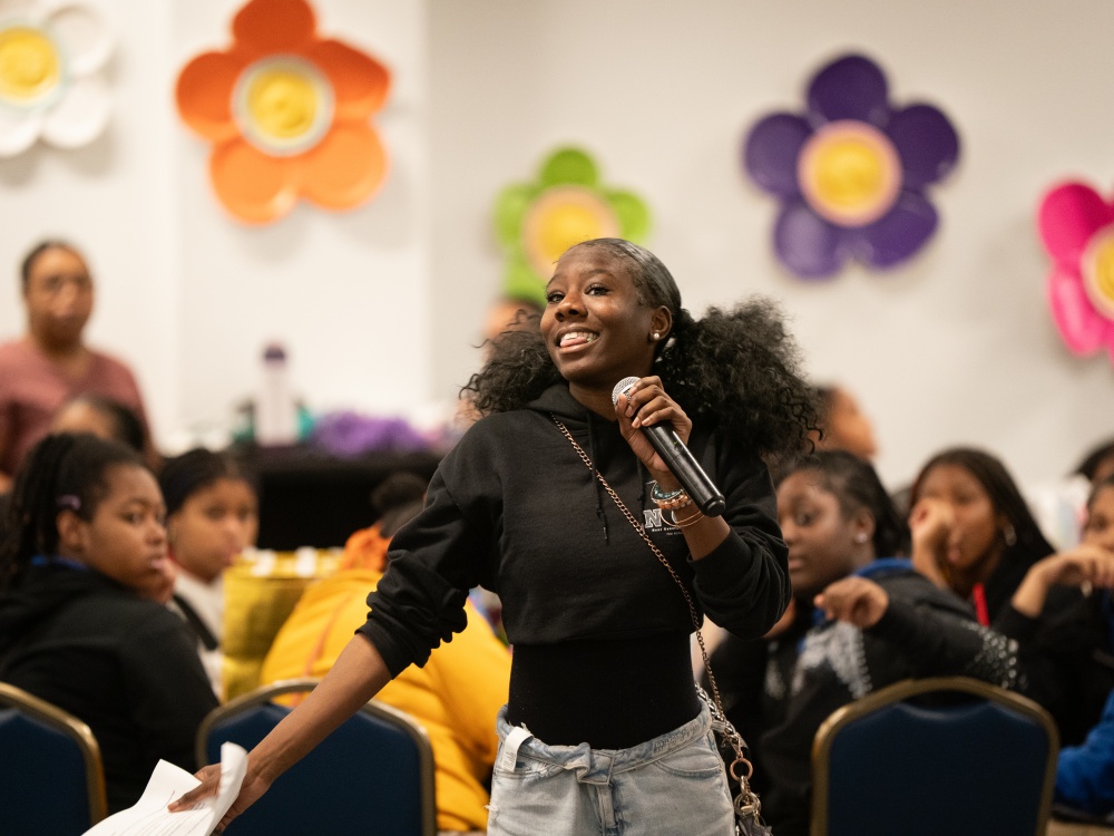 Renaissance Academy 11th-grade student Charde Falcon speaks about revolutionary joy at Bloom.