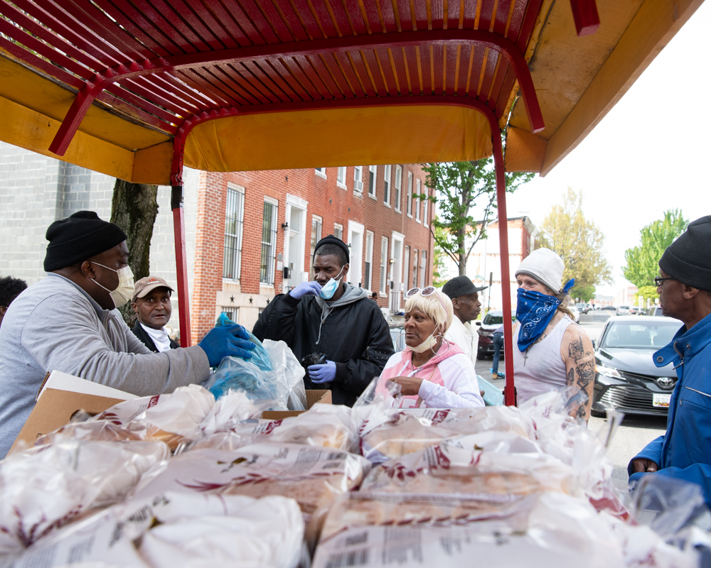The arabbers make stops throughout the neighborhood to distribute food to West Baltimore residents.