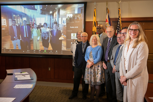 Leaders from the University of Maryland, Baltimore, and virtually, the University of Costa Rica, celebrate the signing of a memorandum of understanding between the two institutions, paving the way to collaborative opportunities exploring aging research.