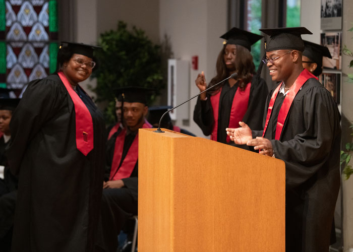 Shakeer Franklin, a Cohort 1 graduate, delivers a student address to the graduating CURE Scholars.