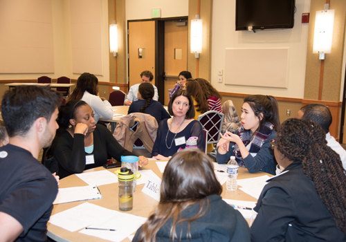 Heather Congdon, Pharm D, BCPS, CDE, assistant dean of the School of Pharmacy program at the Universities at Shady Grove and a co-director of the Center for Interprofessional Education(center), listens in as students from multiple disciplines collaborate on a care plan for a standardized patient during the 6th Annual IPE Day.