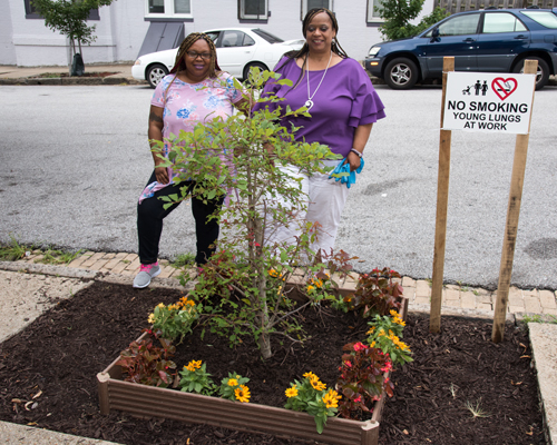From left, Torah Lawson, and Rev. Angela Burden, of New Metropolitan Baptist Church, led a team of church members in creating a garden on Mosher Street as one of many community projects underway in the Upton-Druid Heights neighborhood.