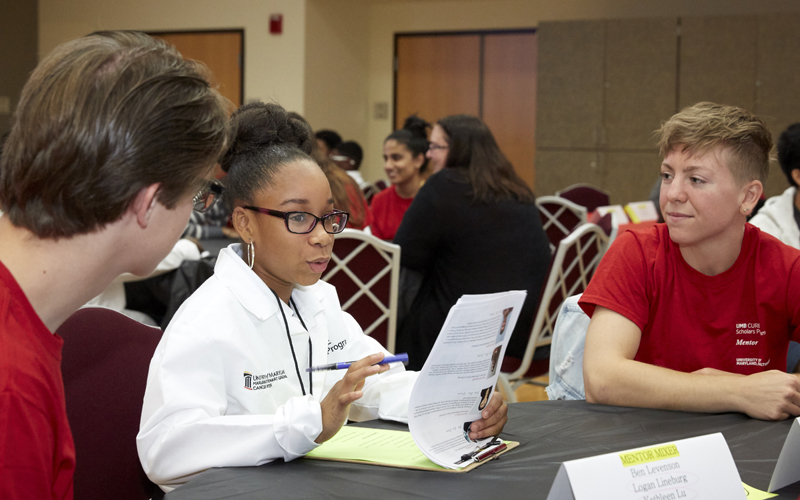 Jamiyah Mitchell (center), a sixth-grader at Southwest Baltimore Charter School and cohort 4 CURE Scholar, interviews her potential mentors at the CURE mentor mixer.