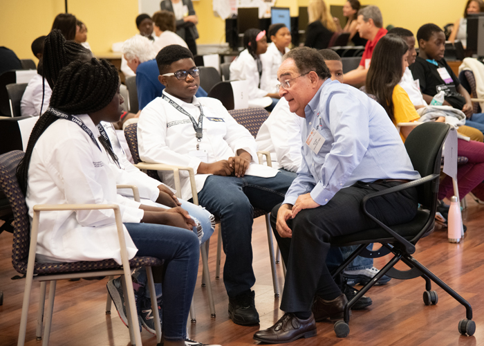 UMB President Jay A. Perman, MD, talks to a group of middle school students in the CURE Scholars Program about their academic aspirations and his own experience in higher education.