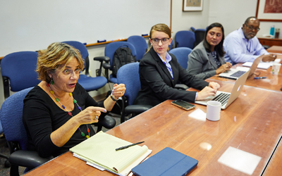 (l-r) Professor Karen Rothenberg, third-year Carey Law students Eleanor Chung and Uma Ramamurthi, and Eggerton Campbell of the National Human Genome Research Institute discuss intellectual property and technology transfer. (Photo: Ernesto Del Aguila, NIH)