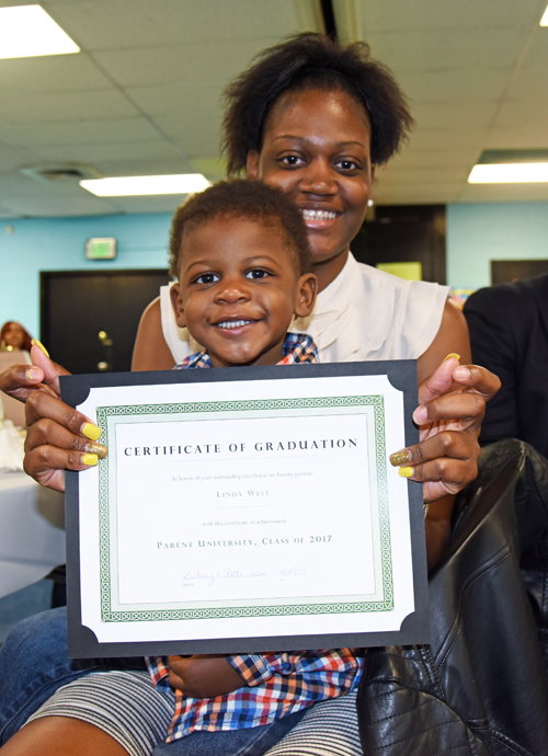 Linda West and her son, Tristan, are all smiles at a Parent University graduation ceremony at the Crispus Attucks Recreation Center. Parent University is one of many Promise Heights programs that will benefit from a new federal grant award.