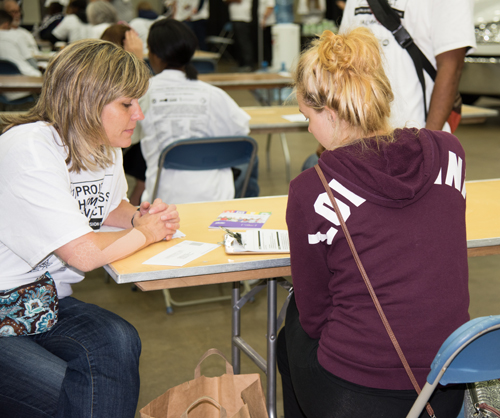 Denise Chop, left, clinical instructor and coordinator for field education at the University of Maryland School of Social Work, assists a client at Project Homeless Connect.