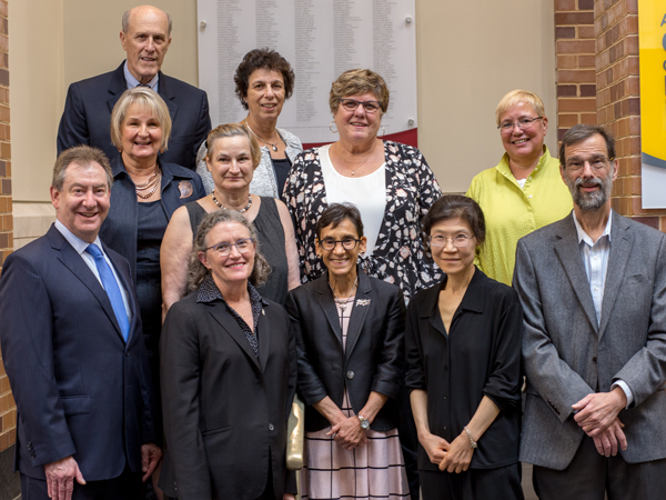 National Library of Medicine Director Patricia Brennan (center, second row) stands with event organizers. 