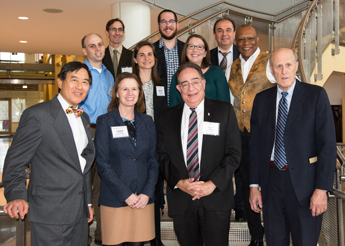 The 2017 UMB-UMCP Seed Grant recipients celebrate a year of research at the UMB-UMCP Seed Grant Symposium with (bottom row, from left) UMCP President Wallace Loh, PhD, JD; Vice President of Research for UMD Laurie Locascio, PhD; UMB President Jay A. Perman, MD; and UMB Executive Vice President, Provost, and Graduate School Dean Bruce Jarrell, MD, FACS.