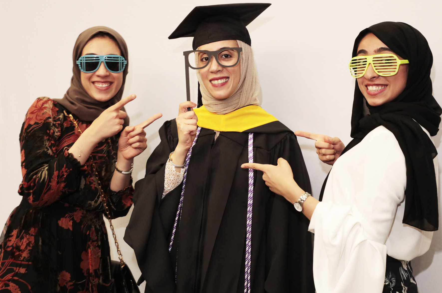 Dooah Almarzoog (center), who was celebrating her Master’s in Community Public Health from the School of Nursing, said she loved the photo booth at the Party in the Park.