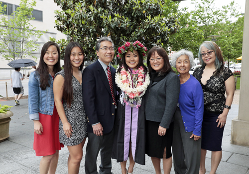 Courtney Miyamoto, DDS '18, (center) poses for a picture with her family, including her parents and grandmother who traveled from Hawaii. She is a third-generation University of Maryland School of Dentistry graduate. Miyamoto created a retrospective video that was shown during the University of Maryland, Baltimore's commencement ceremony May 18, much to the delight of her fellow graduates.