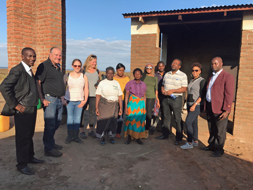 The teams from the University of Maryland Francis King Carey School of Law and the University of Malawi’s Chancellor College of Law are shown meeting with community organizers at a fish-drying site near Lake Chilwa in Malawi.