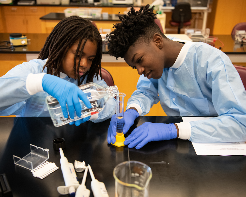 Aniyaa Green (left) and Dayon Wilson (right), CURE Scholars in cohort 1, make a gel for a gel electrophoresis during the Biotechnology Bootcamp at Baltimore City Community College (photo taken in July 2019).