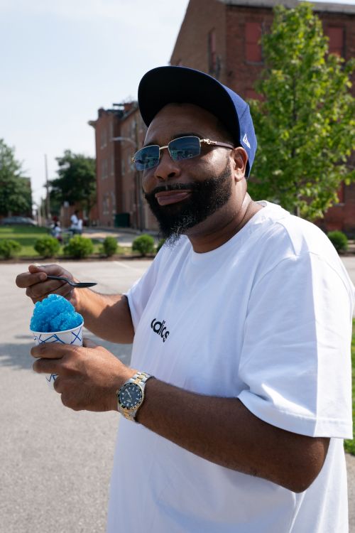 A guest cools off with a colorful snowball, a sweet treat on a warm day at the Juneteenth Jubilee.