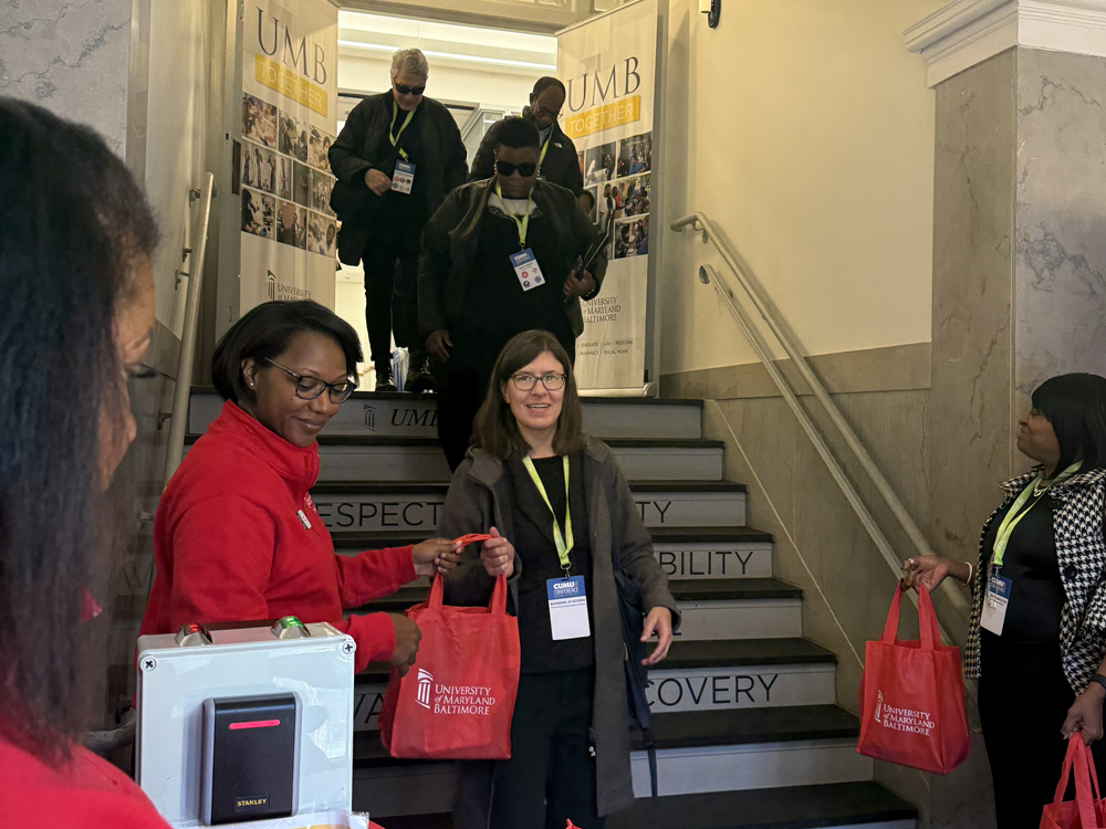 A CUMU attendee leaves the UMB Community Engagement Center after a site visit.
