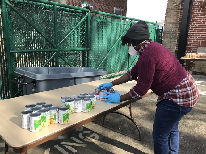 Stephanie Alphee, operations manager for the UMB CURE Scholars Program, sorts donations for the annual Thanksgiving food drive.