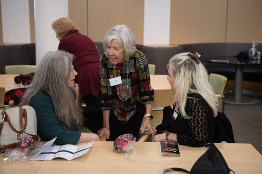 From left, Karen Kabat, Lisa Booze, and Terry Gyi, all former employees of the Maryland Poison Center, catch up with each other during a celebration of the center’s golden anniversary.