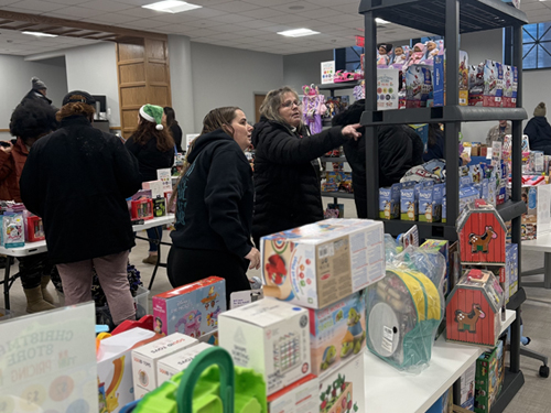 A family browses the Christmas Store, where discounted name-brand toys ranged from arts-and-crafts and science kits to games and dress-up costumes.